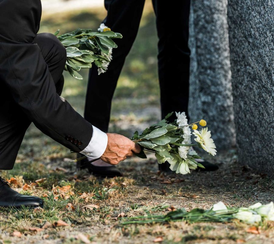 cropped-view-of-senior-man-putting-flowers-near-to-A4V7UQ3.jpg